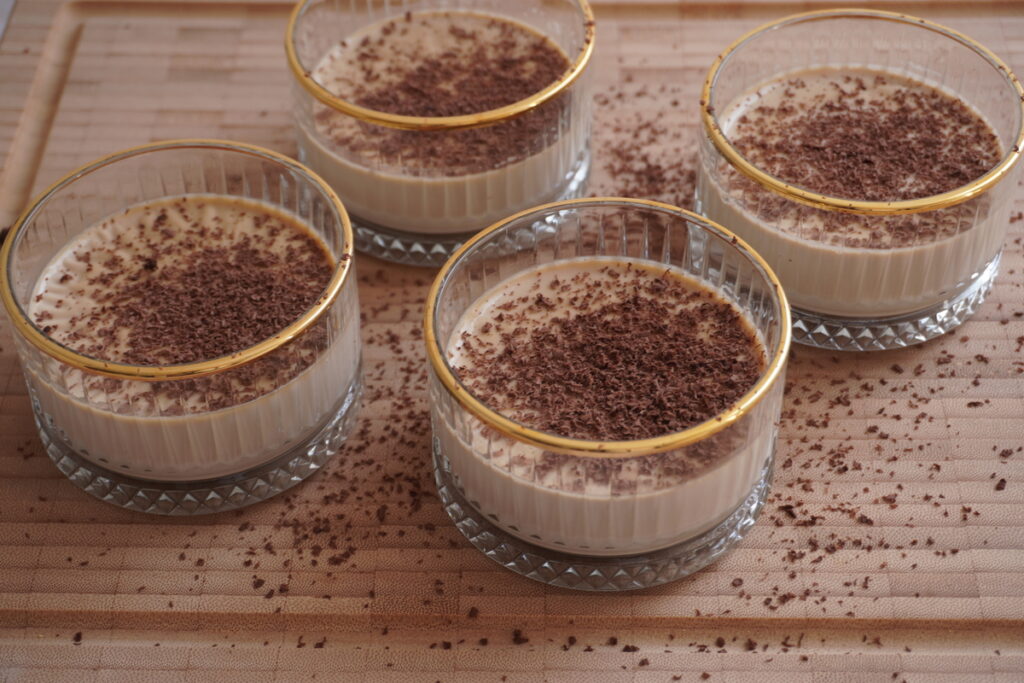 Coffe Panna Cotta in gold rim cups with chocolate shavings
