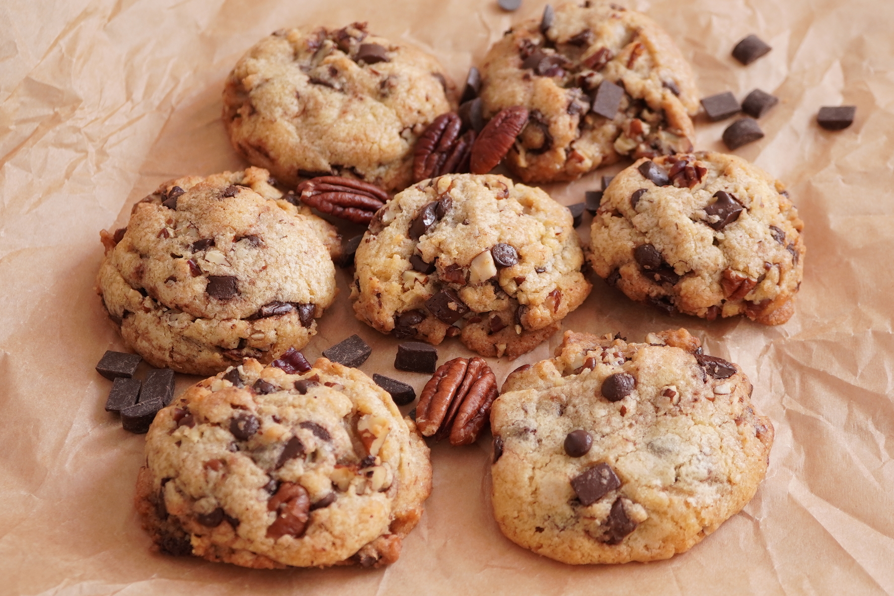 brown butter pecan cookies on bakin paper, pecan halfes