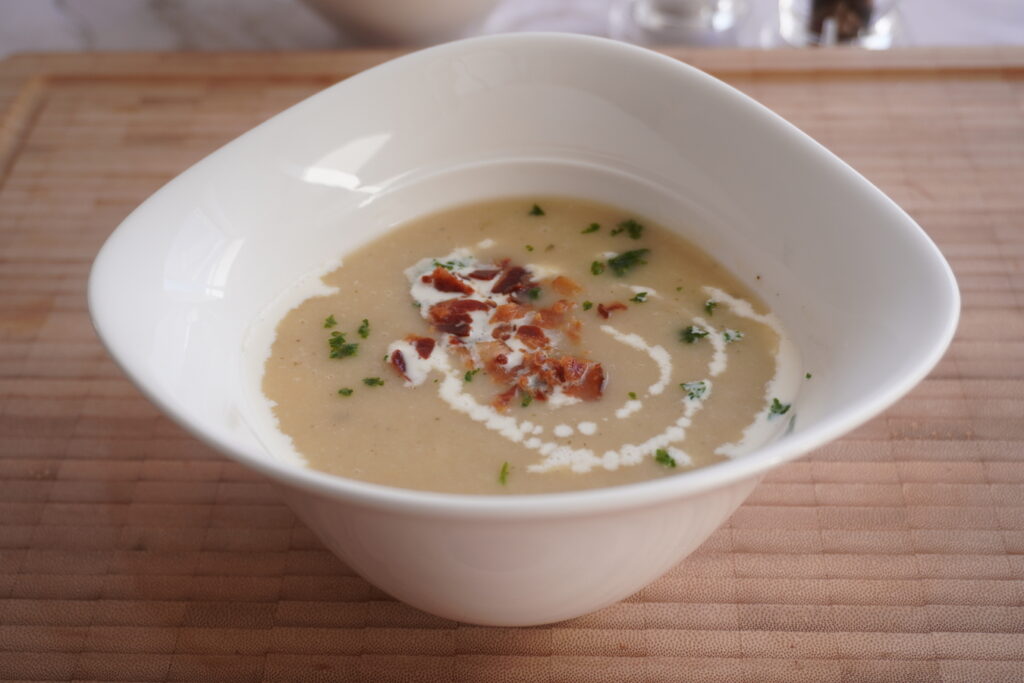 Creamy potato leek soup served in a white Vapiano soup bowl.
